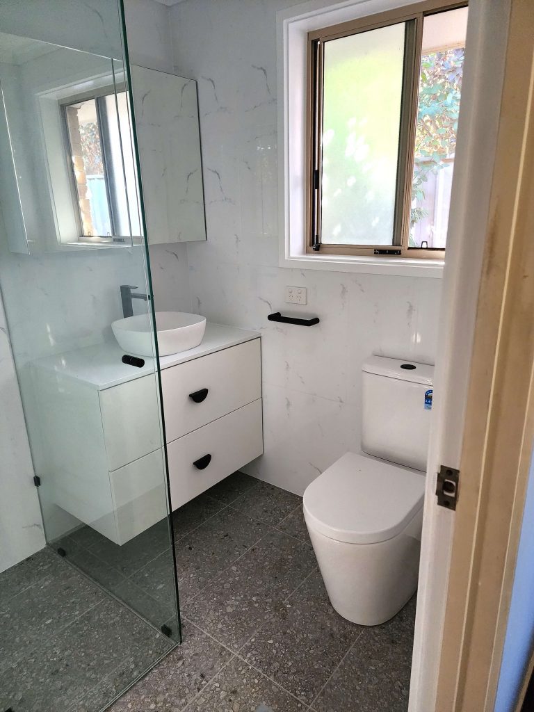 bathroom transformation in Victor Harbor Glass shower screens, floating white vanity and white toilet in a compact bathroom in Victor Harbor.